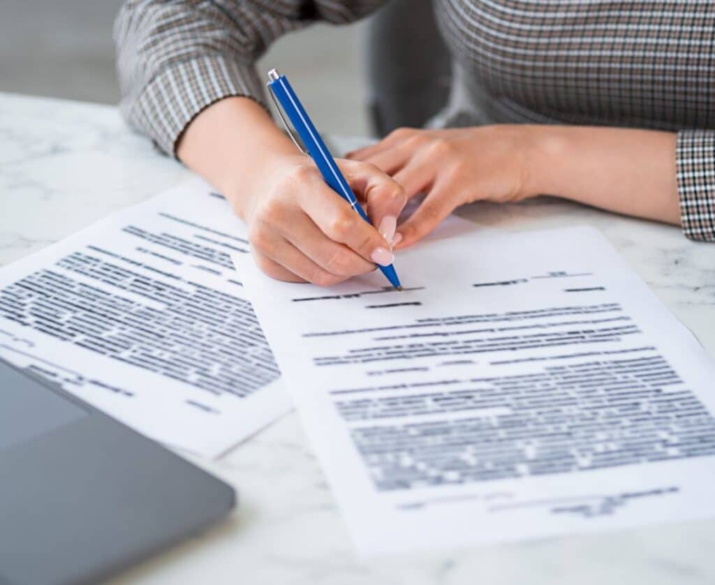 Seller discussing contract terms with a real estate professional while planning to sell my home Twin Falls successfully.